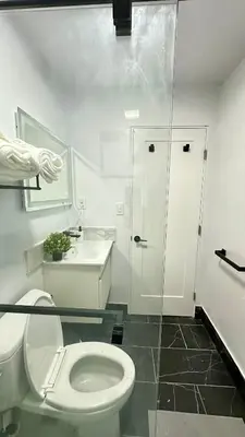 a bathroom with a toilet and a sink and a shower at Modern 2BR Stylish & Cozy Unit in Los Angeles