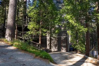 a house in the woods with a balcony at The Mighty Pines Retreat + Large Patio + BBQ+View! in Lake Arrowhead