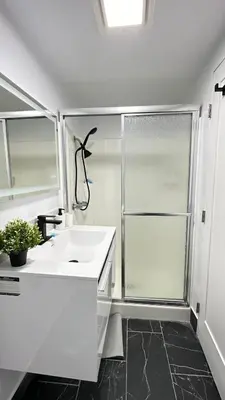 a white bathroom with a sink and a shower at Modern Studio Stylish &Cozy Back Unit in Los Angeles