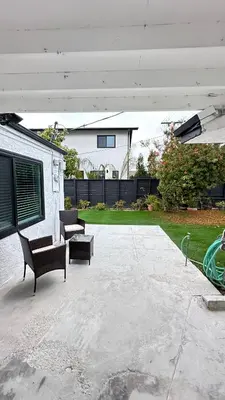 a patio with two chairs and a bench and a house at Modern Studio Stylish &Cozy Back Unit in Los Angeles