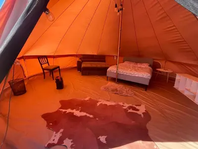 a large tent with a bed and a couch in it at New Yurt City in Lake Los Angeles