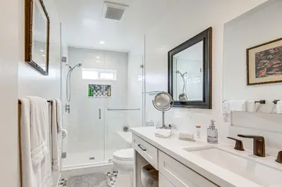a white bathroom with a shower and a sink and a toilet at 2 Blocks to Melrose Ave! Home with Furnished Patio in Los Angeles