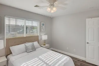 a bedroom with a bed and a ceiling fan at Bakersfield Home with Pool Table, Cornhole and More! in Bakersfield