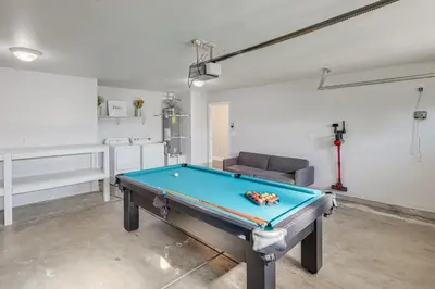 a living room with a pool table in it at Bakersfield Home with Pool Table, Cornhole and More! in Bakersfield
