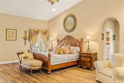 a bedroom with a large bed and a chair at @ Marbella Lane - Hidden Gem in Orange County in Orange