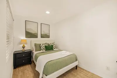 a small bedroom with a bed and a night stand at @ Marbella Lane - Hidden Gem in Orange County in Orange