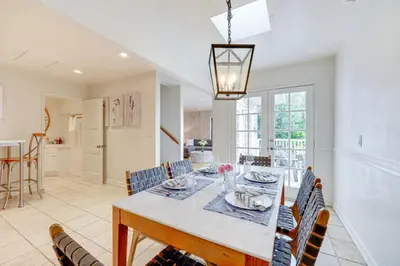 a dining room and kitchen with a table and chairs at Summerland Home with Beach Supplies Walk to Beach! in Summerland