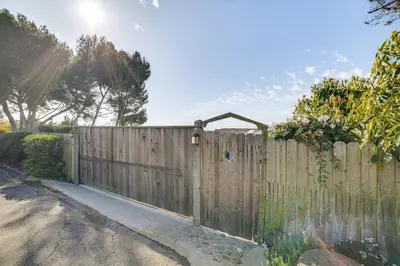 a wooden fence with a gate in a yard at Summerland Home with Beach Supplies Walk to Beach! in Summerland