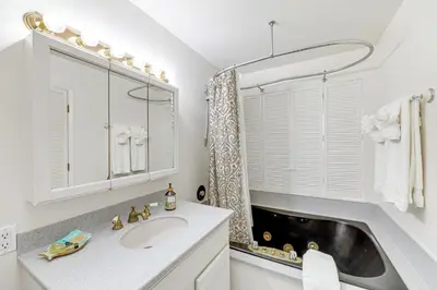 a bathroom with a sink and a mirror at Summerland Home with Beach Supplies Walk to Beach! in Summerland