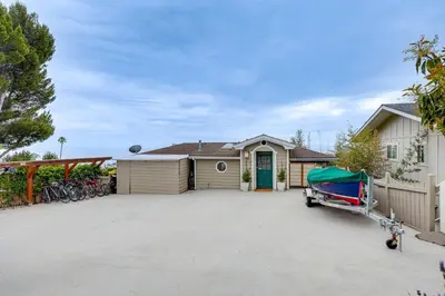 a house with a garage and a driveway at Summerland Home with Beach Supplies Walk to Beach! in Summerland