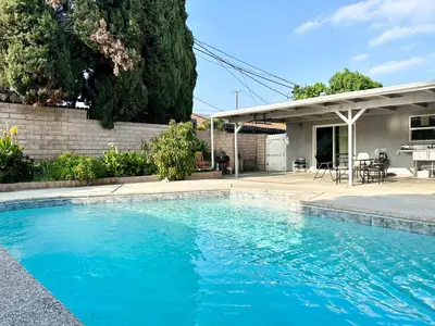 a swimming pool in front of a house at Cheers Hostel in Los Angeles