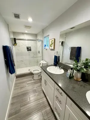 a bathroom with a sink and a toilet and a shower at Cheers Hostel in Los Angeles