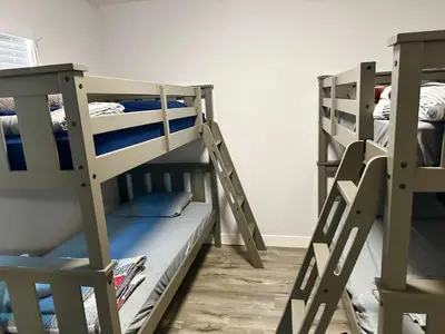 two bunk beds sitting next to each other in a room at Cheers Hostel in Los Angeles