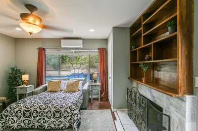 a bedroom with a bed and a large window at Anaheim Studio with Fireplace 14 Mi to Disneyland! in Anaheim