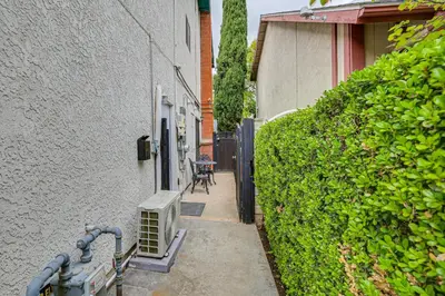 a small alley way with a hedge next to a building at Anaheim Studio with Fireplace 14 Mi to Disneyland! in Anaheim