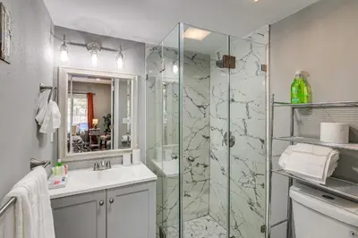 a bathroom with a glass shower and a sink at Anaheim Studio with Fireplace 14 Mi to Disneyland! in Anaheim