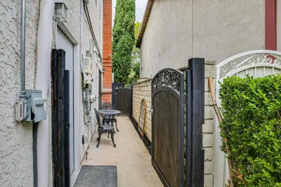 an alley with a table and a fence at Anaheim Studio with Fireplace 14 Mi to Disneyland! in Anaheim