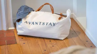 a white bag sitting on a wooden floor at A-Lister by AvantStay Hollywood Hills Luxe Group Escape w Pool in Los Angeles