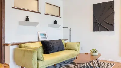 a living room with a yellow couch and a table at A-Lister by AvantStay Hollywood Hills Luxe Group Escape w Pool in Los Angeles