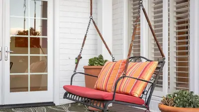 a swing on a porch with plants at A-Lister by AvantStay Hollywood Hills Luxe Group Escape w Pool in Los Angeles