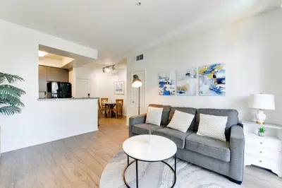 a living room with a couch and a table at Cozy Unit Conveniently Located Pool View in Los Angeles