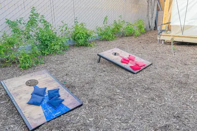 a table with red and blue pillows on the ground at Urban Oasis Luxe Glamping with King Bed & BBQ in Glendora
