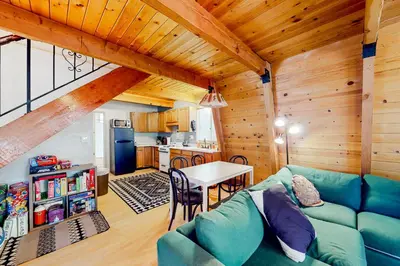 a living room with a blue couch and a table at Hidden Wonder in Crestline