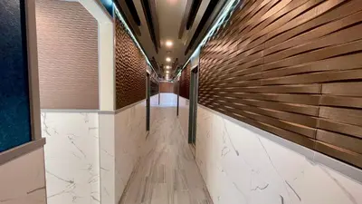 a hallway with wood and stone walls at Quintessence ApartHotel in Los Angeles