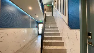 a staircase in a building with blue and white tiles at Quintessence ApartHotel in Los Angeles