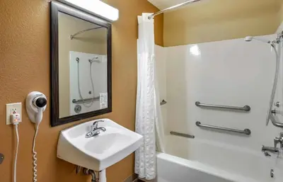 a bathroom with a sink and a shower at Relax Suites Extended Stay - La Mirada in La Mirada