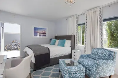 a bedroom with a bed and a couch and a chair at Beautiful renovated studio close to ocean! in Los Angeles