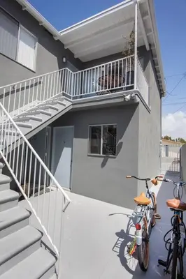 two bikes parked next to a building with a balcony at Beautiful renovated studio close to ocean! in Los Angeles