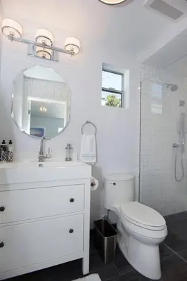 a white bathroom with a toilet and a sink at Beautiful renovated studio close to ocean! in Los Angeles