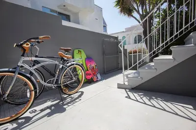 a bike parked next to a wall with a skateboard at Beautiful renovated studio close to ocean! in Los Angeles