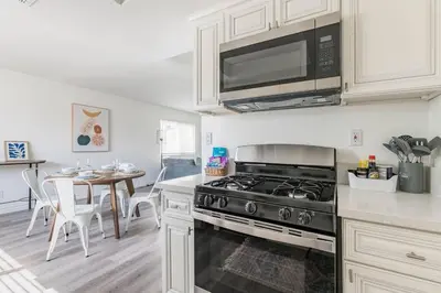 a kitchen with a stove and a dining room at Enjoy Alhambra Night Life at 2BR Apt in Alhambra