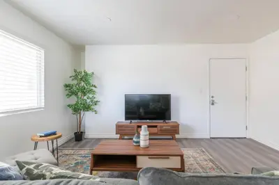 a living room with a couch and a tv at Enjoy Alhambra Night Life at 2BR Apt in Alhambra