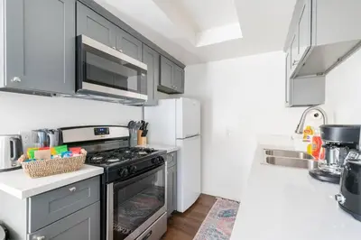 a kitchen with a stove and a microwave at 4 bedroom Alhambra Condo near downtown LA in Alhambra