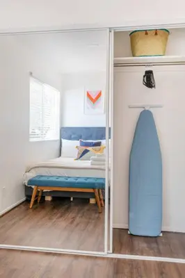 a mirror in a room with a bed and a surfboard at 4 bedroom Alhambra Condo near downtown LA in Alhambra