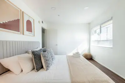 a bedroom with a white bed with pillows on it at 4 bedroom Alhambra Condo near downtown LA in Alhambra