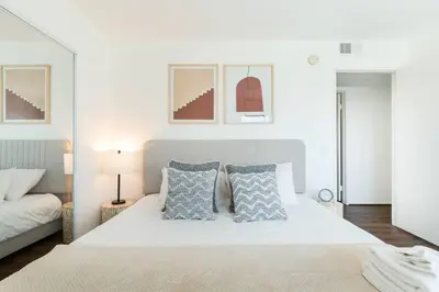 a bedroom with a large white bed with pillows at 4 bedroom Alhambra Condo near downtown LA in Alhambra