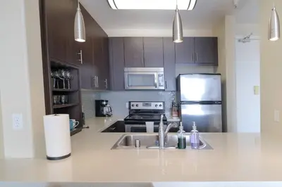 a kitchen with a sink and a stainless steel refrigerator at Vacation Apartments in Marina Del Rey in Los Angeles