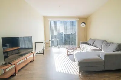a living room with a couch and a flat screen tv at Vacation Apartments in Marina Del Rey in Los Angeles