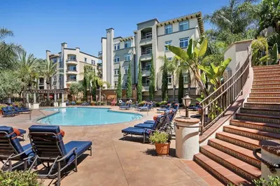 a swimming pool with lounge chairs and buildings at Vacation Apartments in Marina Del Rey in Los Angeles