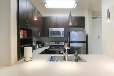 a kitchen with a sink and a refrigerator at Vacation Apartments in Marina Del Rey in Los Angeles