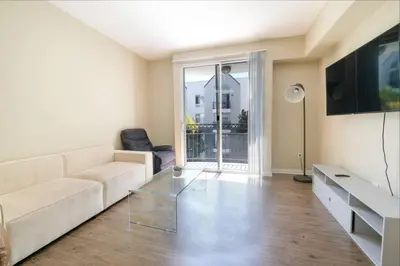 a living room with a couch and a glass coffee table at Vacation Apartments in Marina Del Rey in Los Angeles