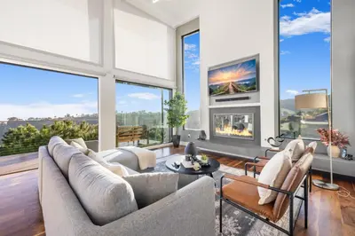 a living room filled with furniture and large windows at Summitridge in Los Angeles