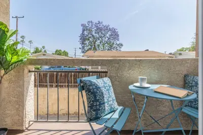 a blue table and chair on a balcony at Modern 2BR Condo with King Bed & Balcony near LA in Alhambra