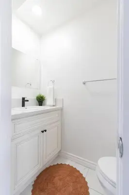 a bathroom with a sink and a toilet and a mirror at Modern 2BR Condo with King Bed & Balcony near LA in Alhambra