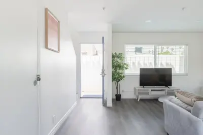 a white living room with a tv and a couch at Modern 2BR Condo with King Bed & Balcony near LA in Alhambra