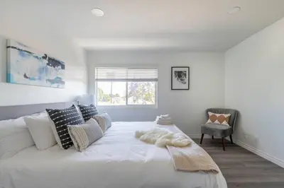 a bedroom with a large white bed with a window at Modern 2BR Condo with King Bed & Balcony near LA in Alhambra